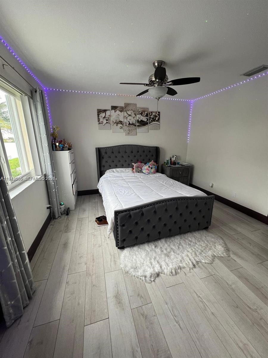 17401 Southwest 140th Court Miami, FL 33177 - Photo 30 of 42 a spacious bedroom with a bed and a dresser