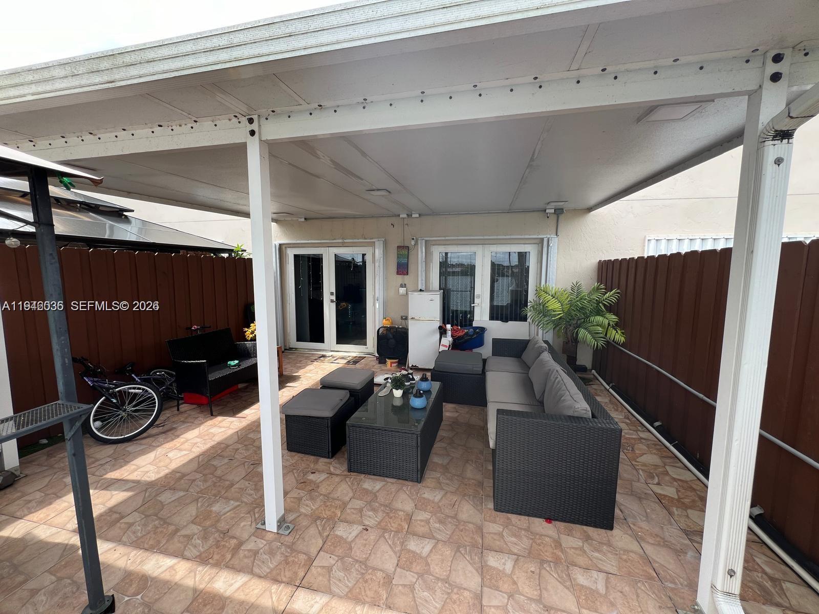 17401 Southwest 140th Court Miami, FL 33177 - Photo 40 of 42 a living room with furniture a flat screen tv and a large window