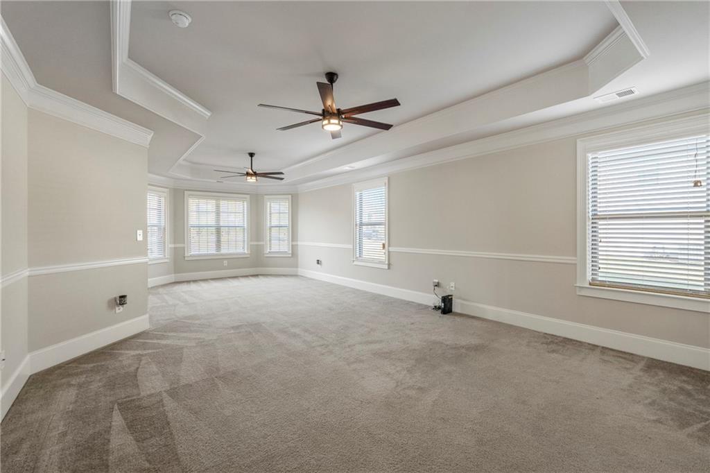 12 Juno Street Fort Mitchell, AL 36856 - Photo 15 of 43 Unfurnished room with a raised ceiling, light colored carpet, a ceiling fan, and ornamental molding