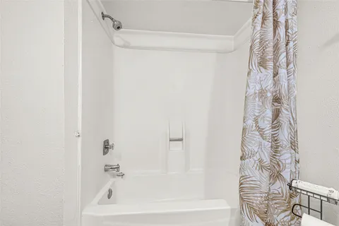 a bathroom with a bathtub and shower