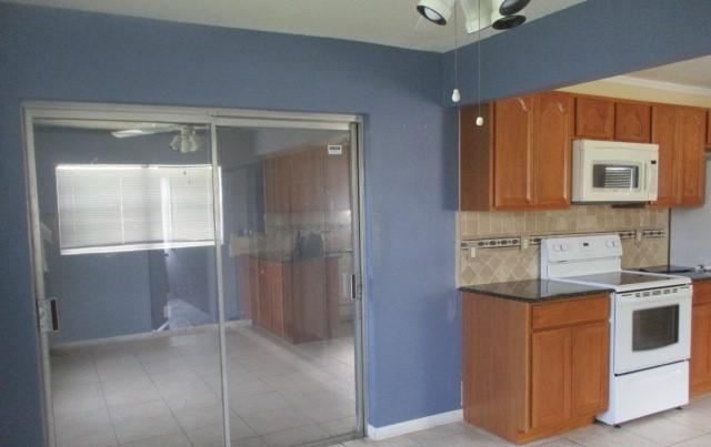23097 Southwest 60th Way Boca Raton, FL 33428 - Photo 9 of 18 a kitchen with stainless steel appliances granite countertop a refrigerator and a stove