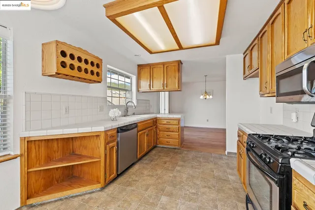 a kitchen with stainless steel appliances granite countertop a stove and a sink