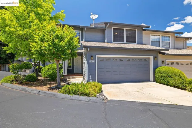 a front view of a house with a yard and a garage