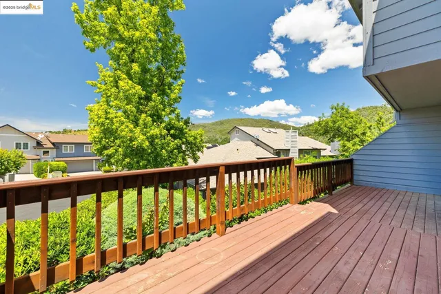 a view of a house with wooden deck