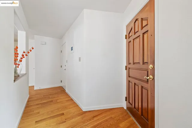 a view of a hallway with wooden floor and entryway