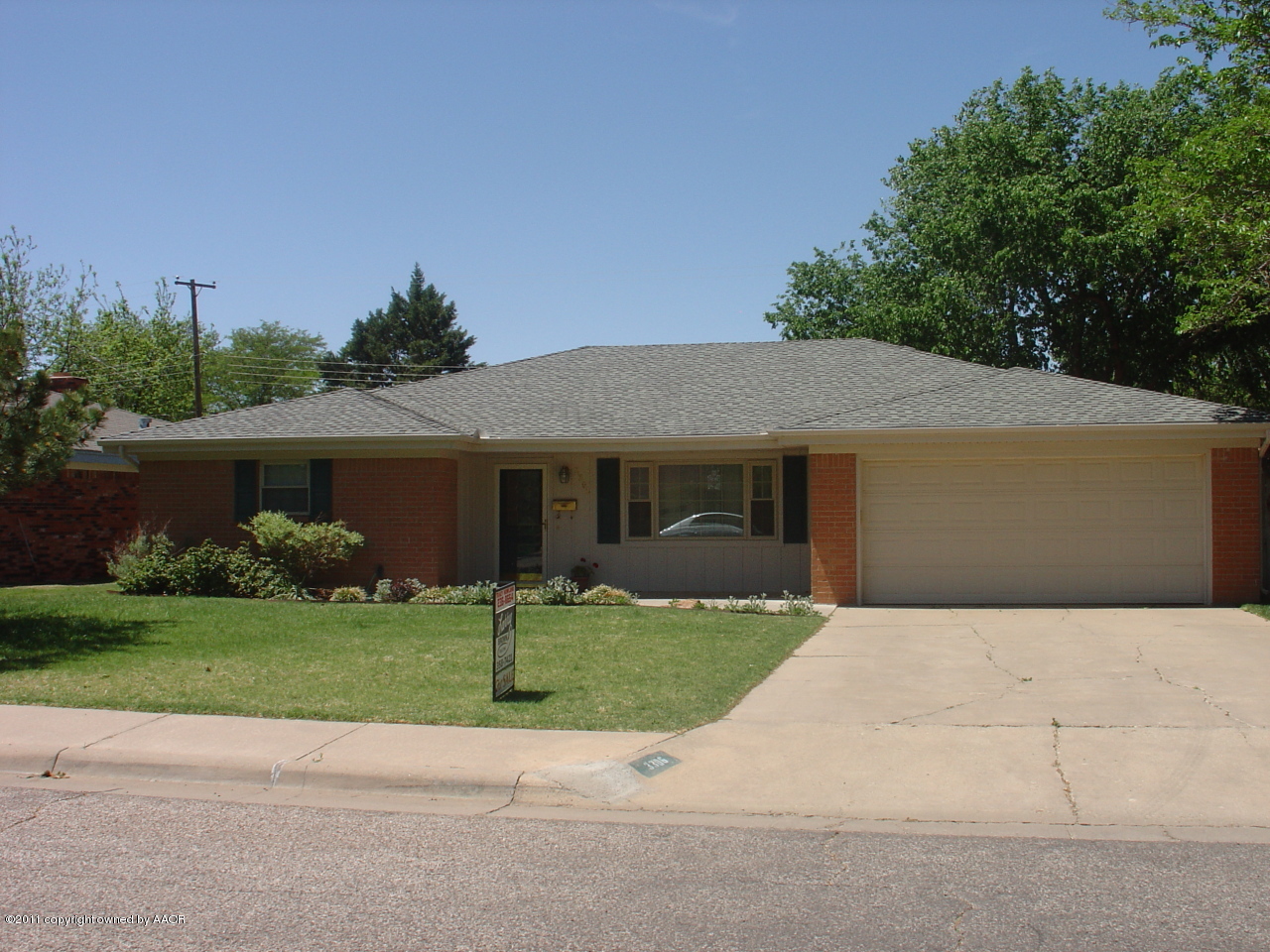 3306 Bedford Road Amarillo, TX 79106 - Photo 19 of 19 a front view of a house with a yard and garage