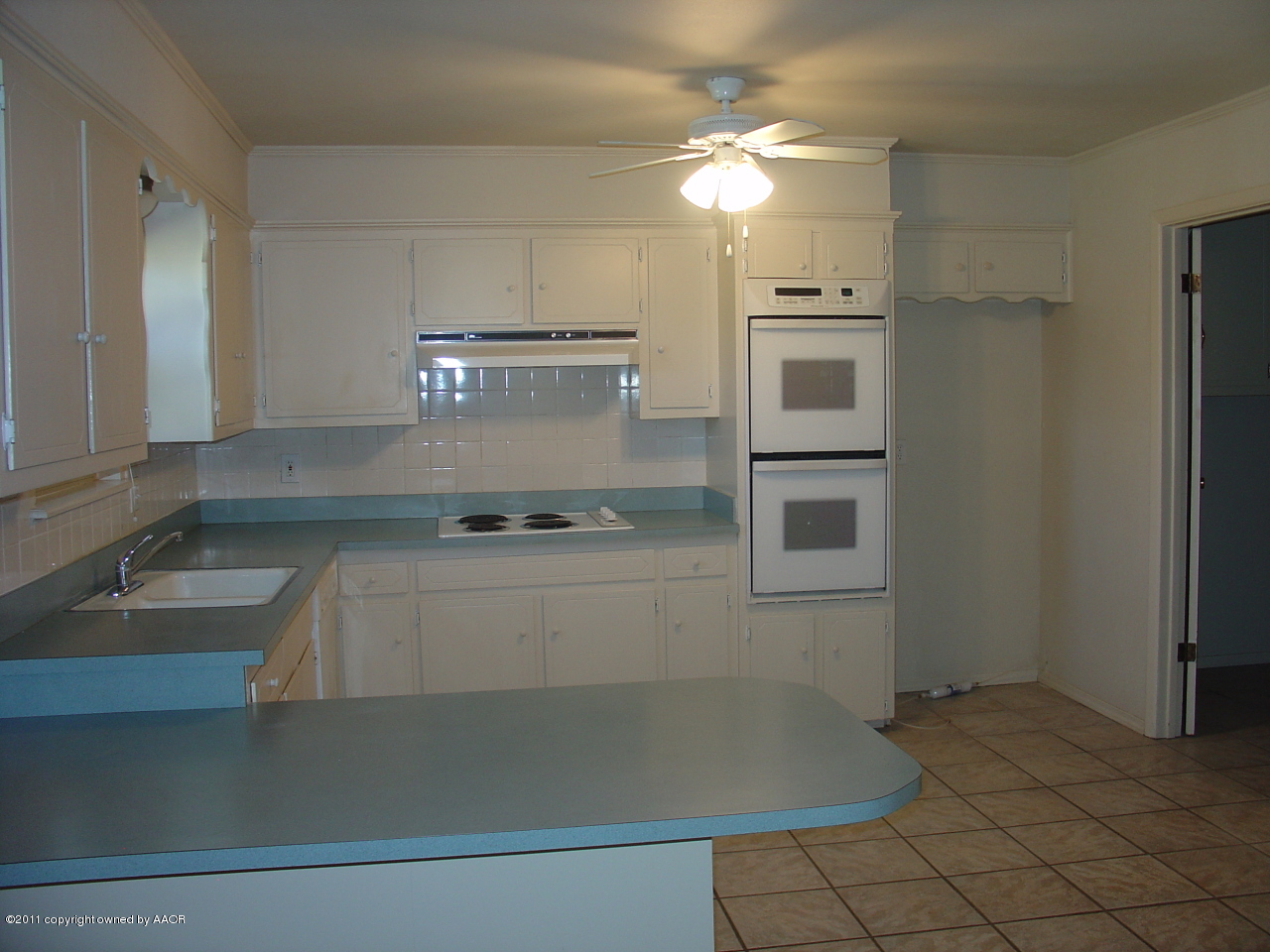 3306 Bedford Road Amarillo, TX 79106 - Photo 7 of 19 a kitchen with kitchen island a sink appliances and cabinets