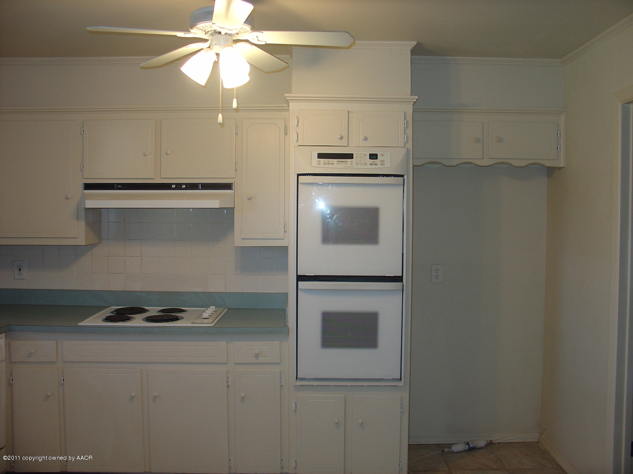 3306 Bedford Road Amarillo, TX 79106 - Photo 8 of 19 a kitchen with a stove and white cabinets