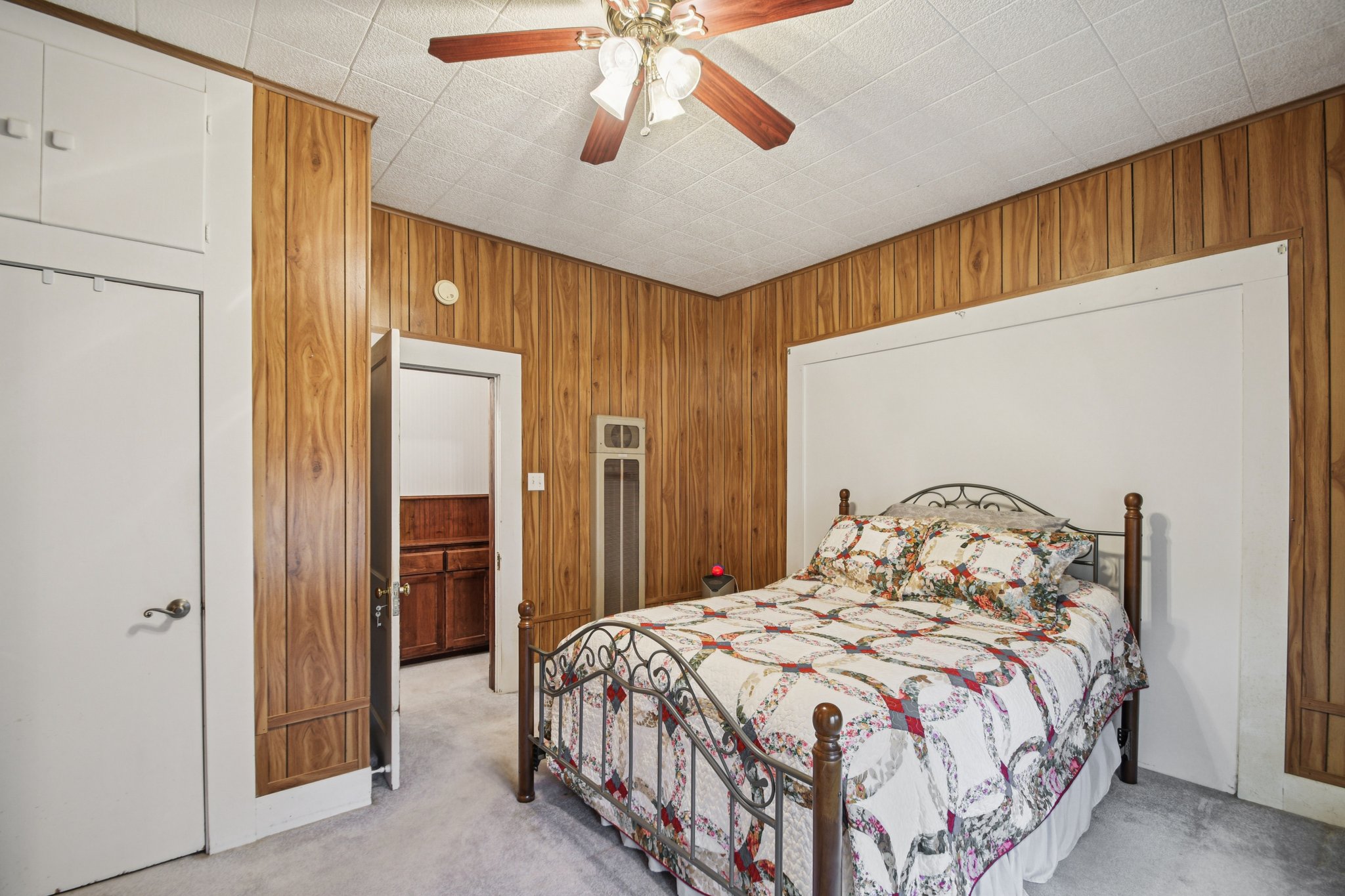 611 North Main Street Elgin, TX 78621 - Photo 20 of 26 a bedroom with a bed and a chandelier