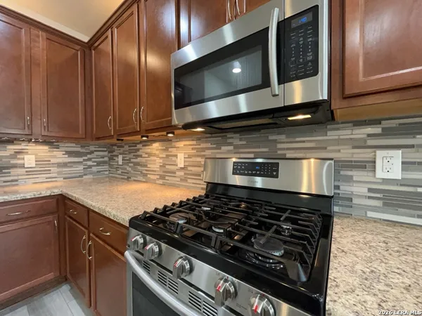 a stove top oven sitting inside of a kitchen