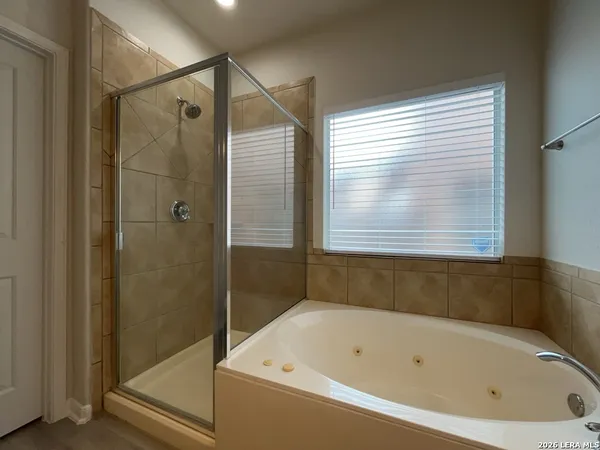 a bathroom with a bathtub and a shower