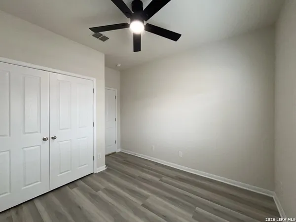 an empty room with a ceiling fan