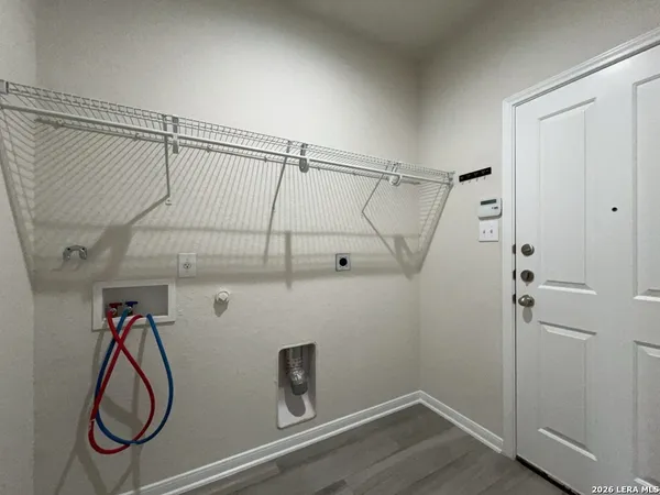 a view of a storage & utility room with racks on the wall