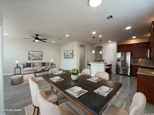 a living room with furniture kitchen view and a dining table