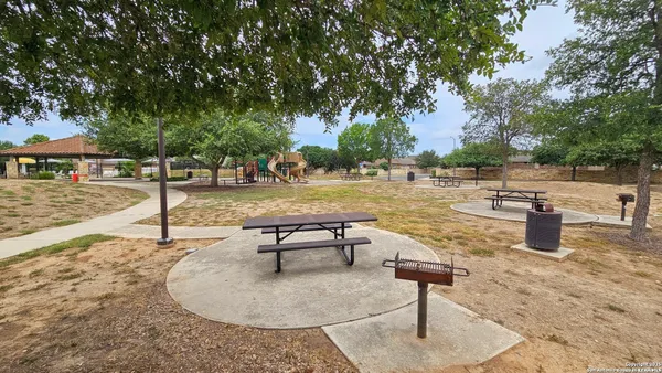 an aerial view of residential house with outdoor space and car parked