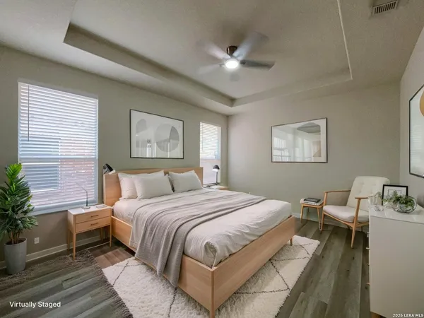 a bedroom with a large bed and a chandelier