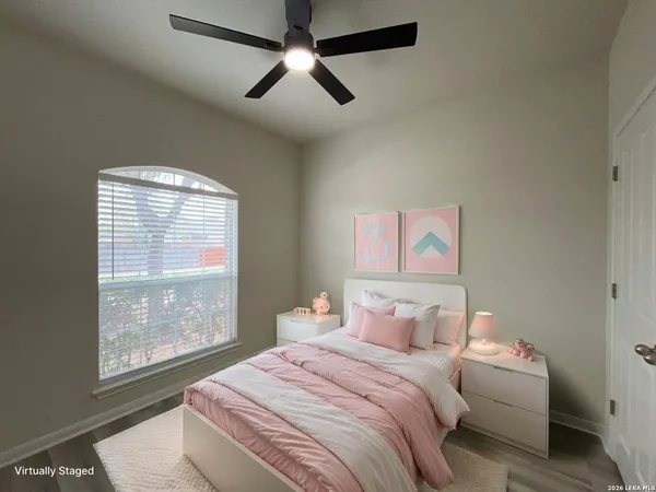 a bedroom with a large bed and a window