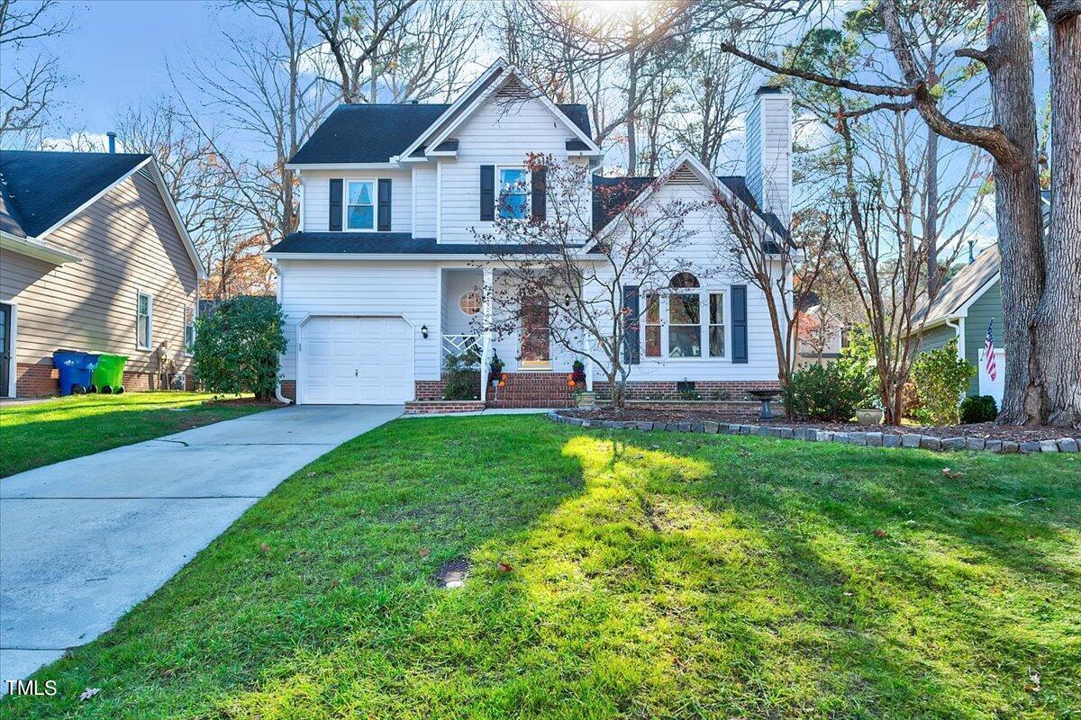 11925 Fairlie Place Raleigh, NC 27613 - Photo 1 of 22 a front view of a house with a yard and garage