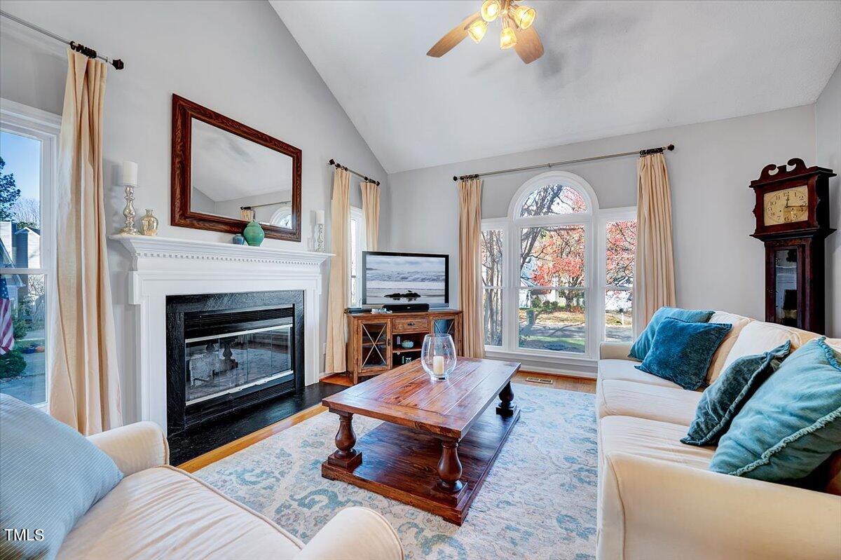 11925 Fairlie Place Raleigh, NC 27613 - Photo 5 of 22 a living room with furniture and a fireplace