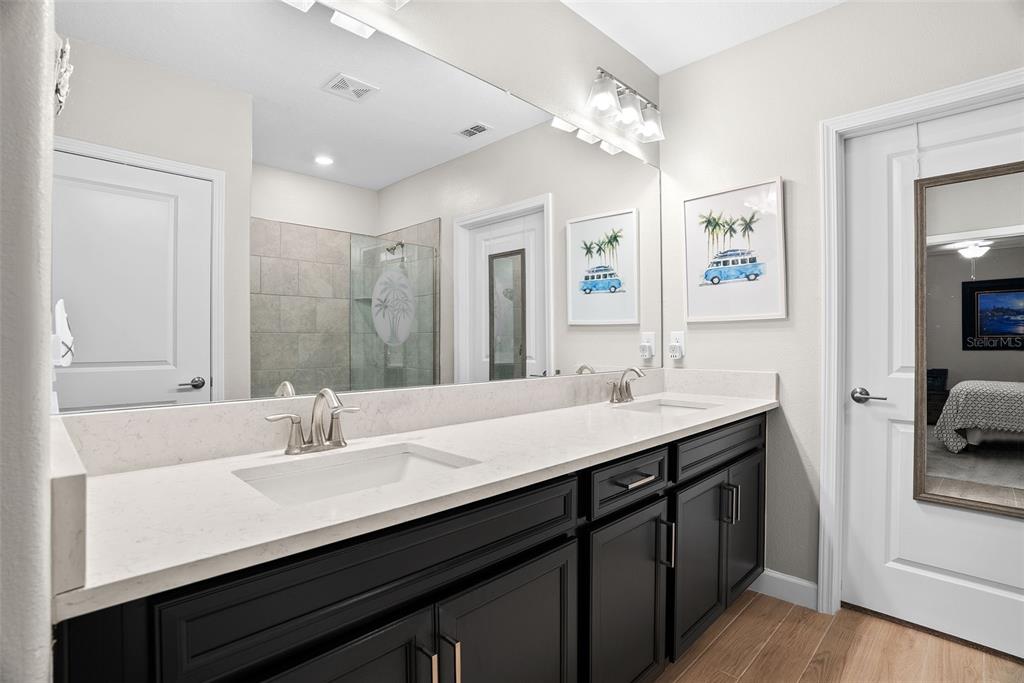 10232 Echo Dock Loop San Antonio, FL 33576 - Photo 24 of 43 a bathroom with a sink double vanity and a mirror