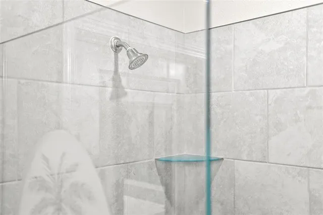 a white toilet sitting next to a white wall