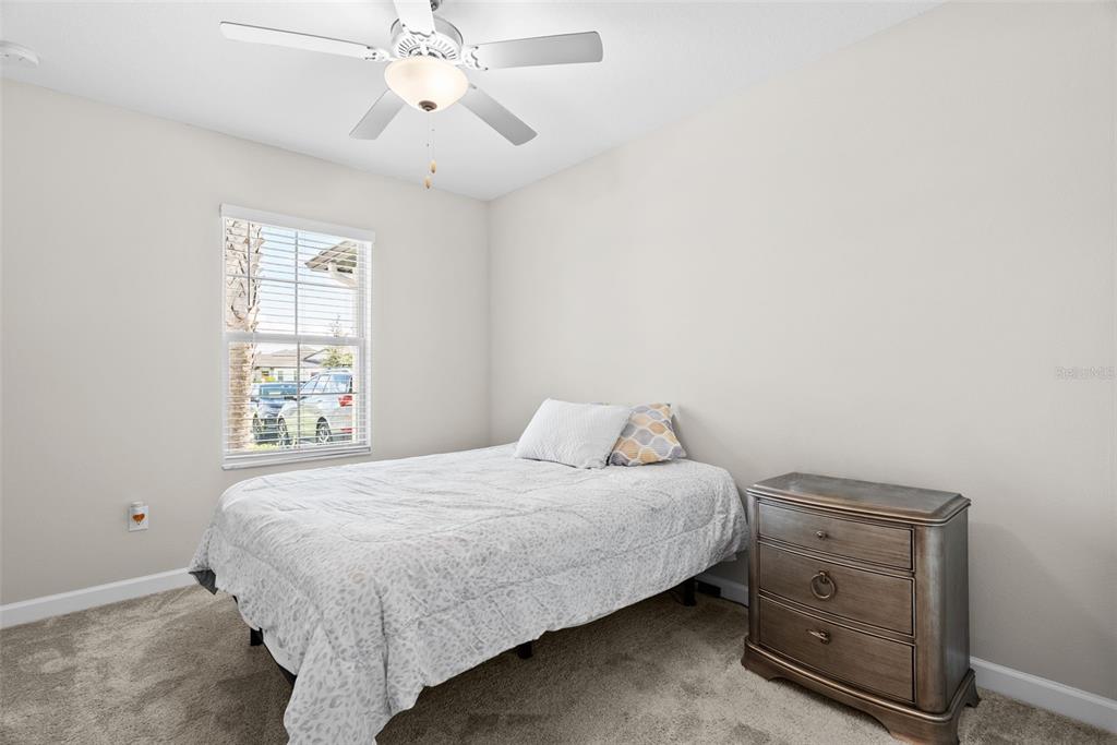 10232 Echo Dock Loop San Antonio, FL 33576 - Photo 30 of 43 a bedroom with a bed and a window