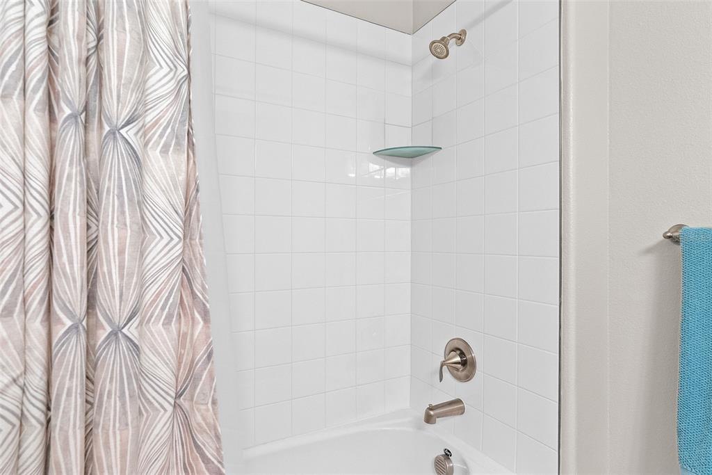 10232 Echo Dock Loop San Antonio, FL 33576 - Photo 33 of 43 a bathroom with a bathtub and shower