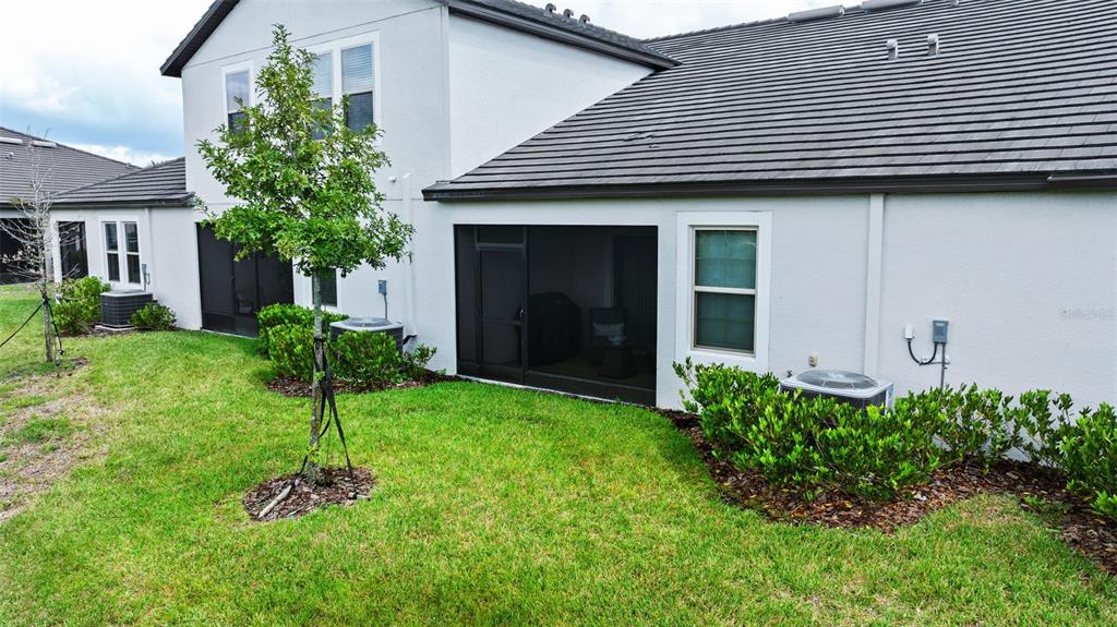 10232 Echo Dock Loop San Antonio, FL 33576 - Photo 38 of 43 a front view of a house with a garden and plants