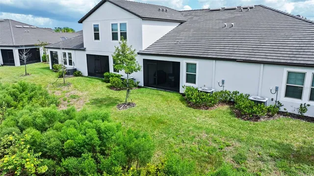 an aerial view of residential houses with outdoor space and swimming pool