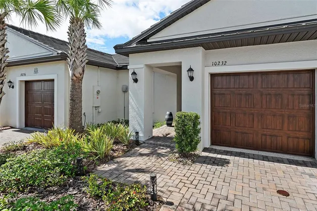 a couple of potted plants in front of door