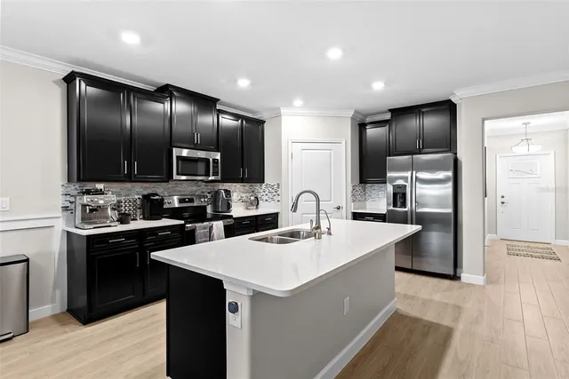 a kitchen with a sink stove and refrigerator