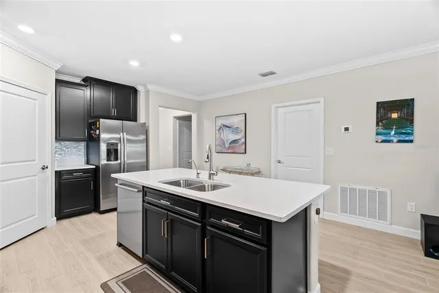 a kitchen with stainless steel appliances a sink stove and cabinets