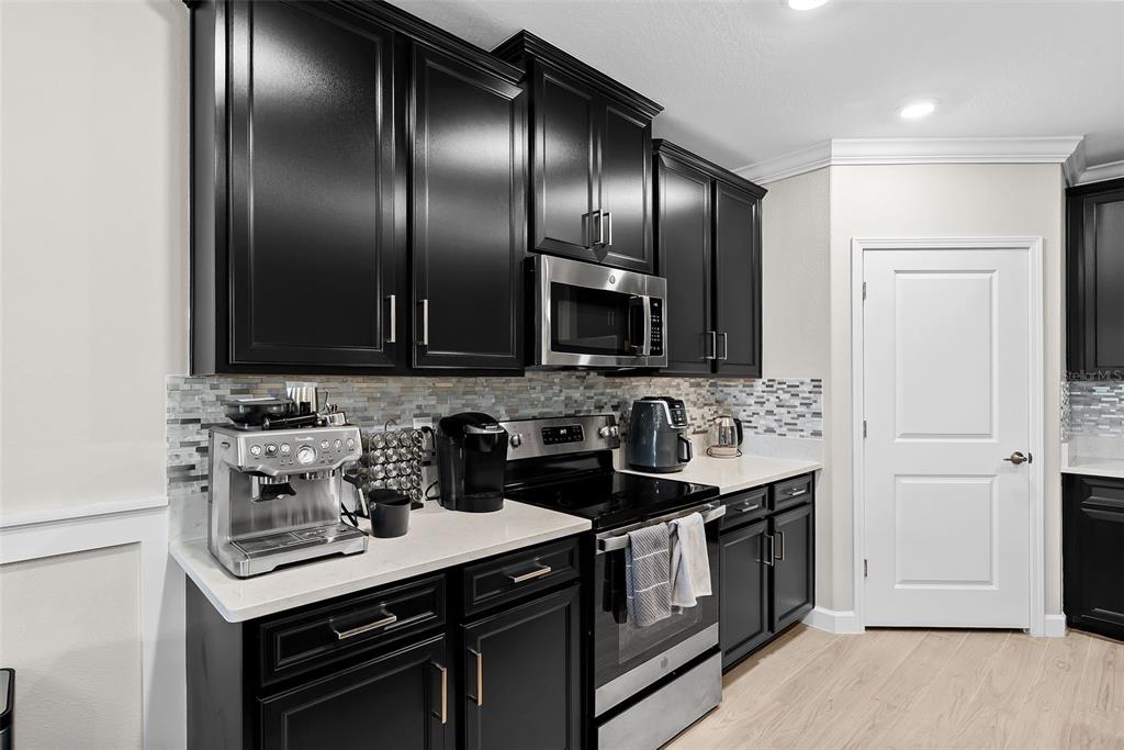 10232 Echo Dock Loop San Antonio, FL 33576 - Photo 10 of 43 a kitchen with stainless steel appliances a sink stove and cabinets