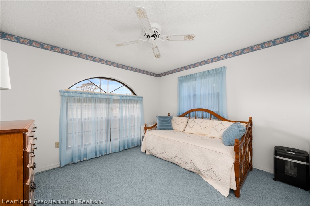 5802 Golden Road Sebring, FL 33875 - Photo 21 of 37 a bedroom with a bed and a dresser