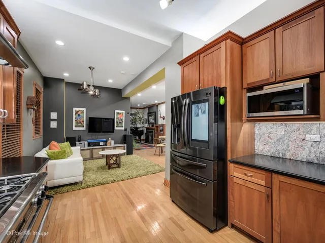 a kitchen with stainless steel appliances granite countertop a refrigerator stove microwave and sink