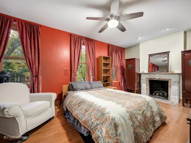 a spacious bedroom with a large bed and a fireplace