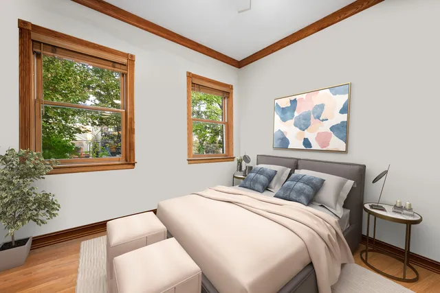 a bedroom with a bed and a painting on the wall