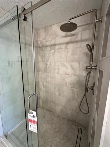 a bathroom with a granite countertop sink a toilet and a mirror