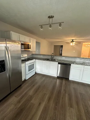 a kitchen with a stove and a white counter top