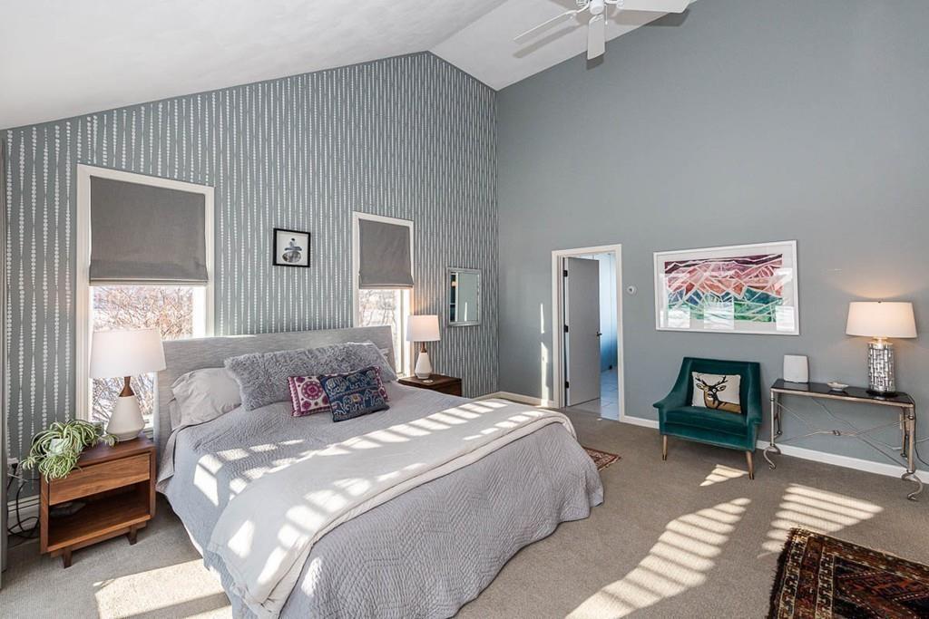 72 Island Road Essex, MA 01929 - Photo 22 of 40 a bedroom with a bed a couch and a flat screen tv