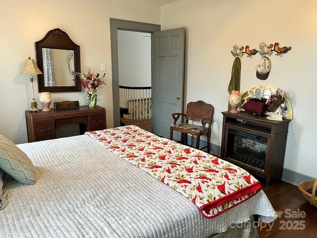 a bedroom with a bed and dresser with mirror