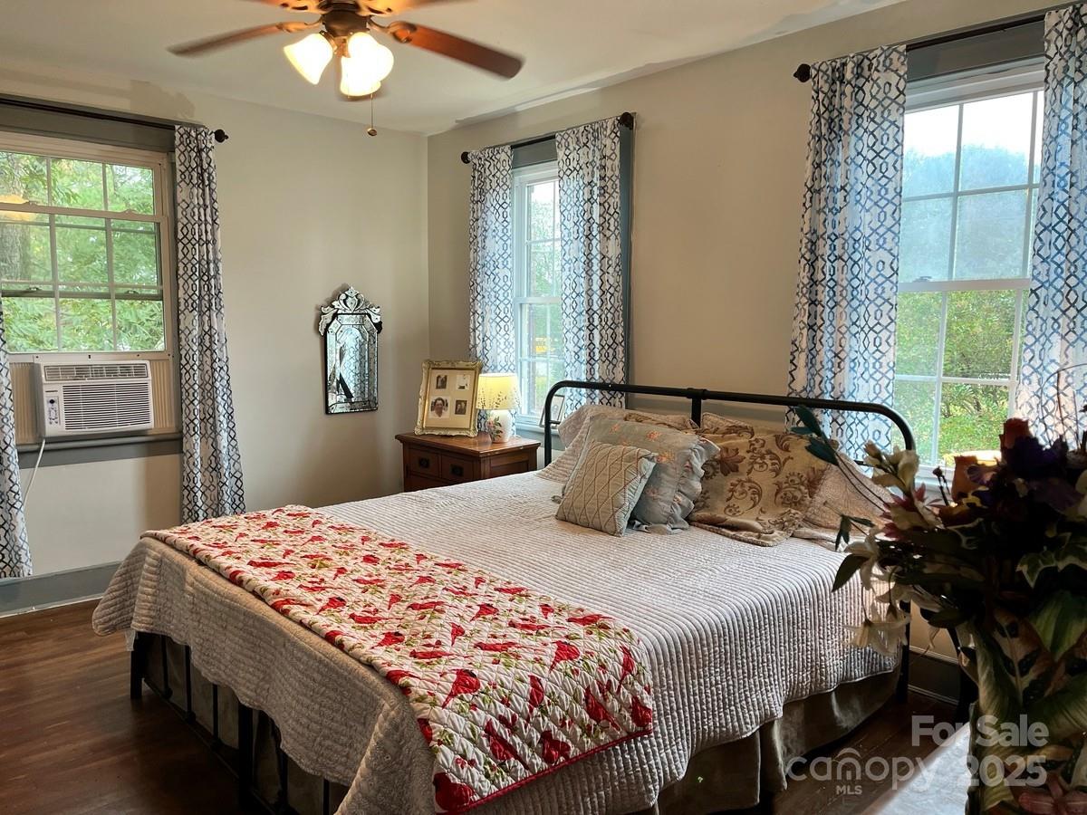 423 East Main Street Conway, NC 27820 - Photo 13 of 44 a bedroom with a bed and a chandelier