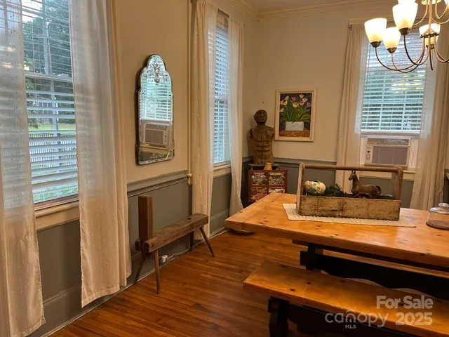 a view of a dining room with furniture and a window