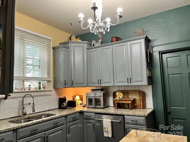 a kitchen with stainless steel appliances granite countertop a refrigerator and sink