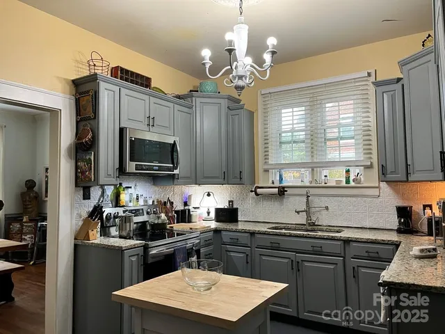 a kitchen with a sink stove and microwave