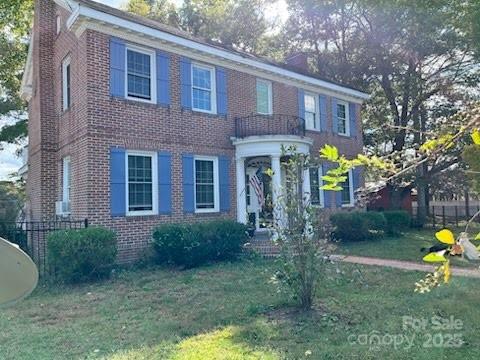 423 East Main Street Conway, NC 27820 - Photo 2 of 44 a view of a brick house with a yard and plants
