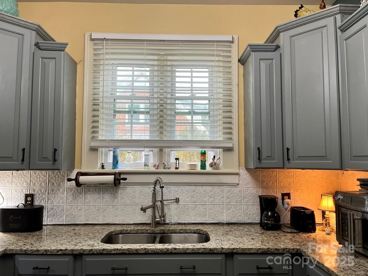 423 East Main Street Conway, NC 27820 - Photo 22 of 44 a kitchen with granite countertop a sink and a counter top space