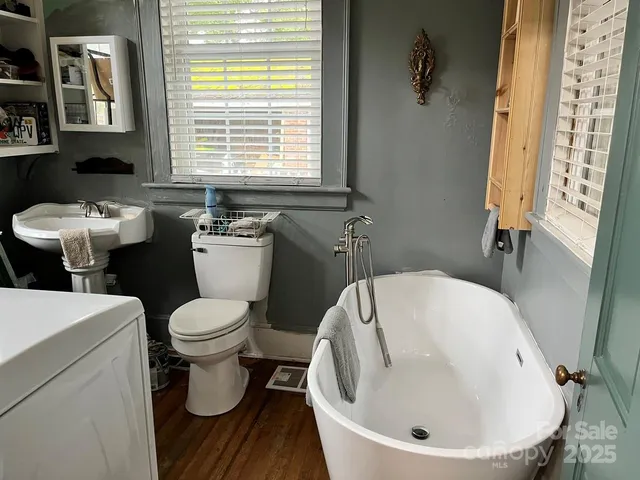 a bathroom with a sink and mirror with toilet