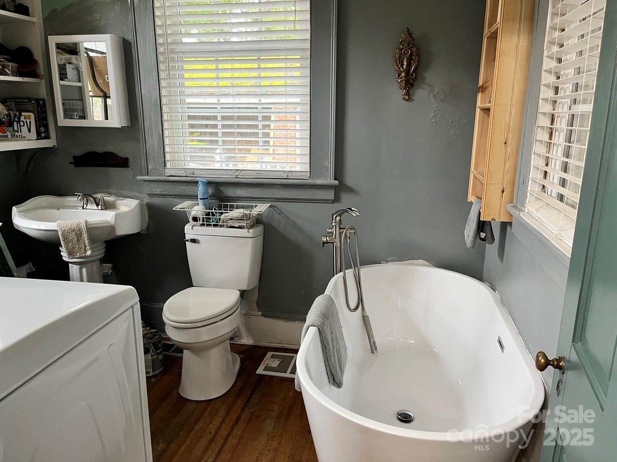 423 East Main Street Conway, NC 27820 - Photo 23 of 44 a bathroom with a sink and mirror with toilet