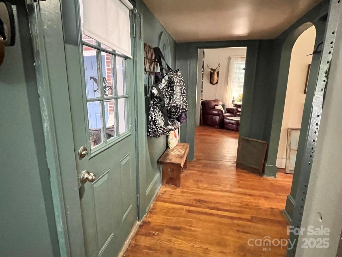 423 East Main Street Conway, NC 27820 - Photo 26 of 44 a view of a hallway with wooden floor and living room